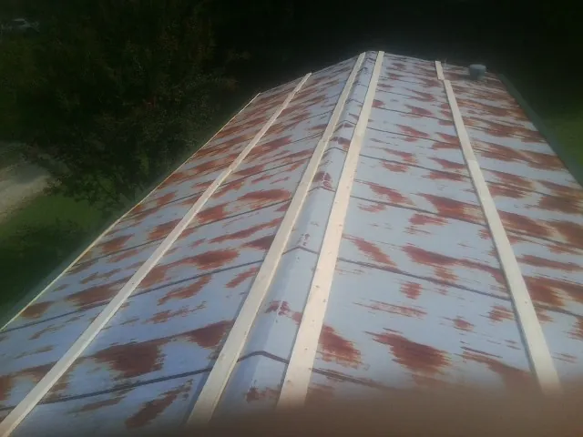 Rusted metal roof panels with new wood purlins before replacement — Storm Damage Roof Repair in Fultonham by Roofing Brothers