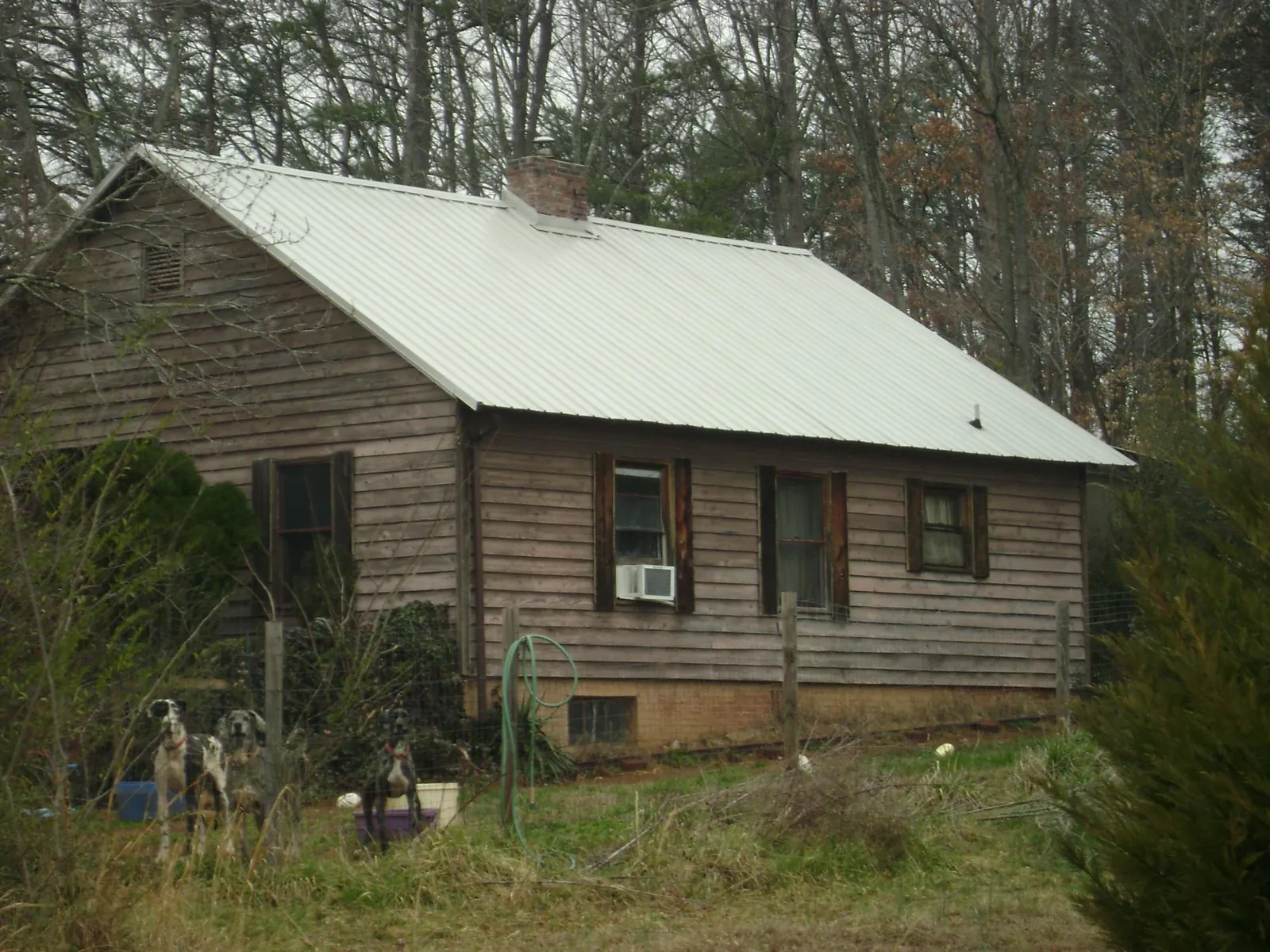 White metal roof on an old wood sided farmhouse, from a Metal Roof Installation job in Fultonham